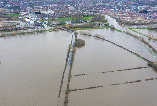 Aerial drone photo of the town of Allerton Bywater near Castleford in Leeds West Yorkshire showing the flooded fields and farm house from the River Aire during a large flood after a storm.