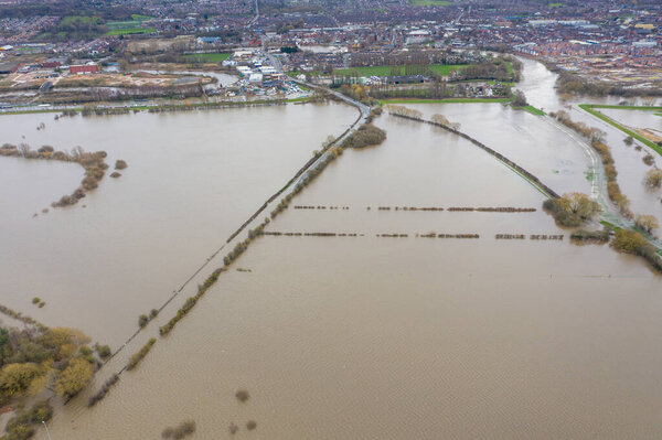 Aerial drone photo of the town of Allerton Bywater near Castleford in Leeds West Yorkshire showing the flooded fields and farm house from the River Aire during a large flood after a storm.