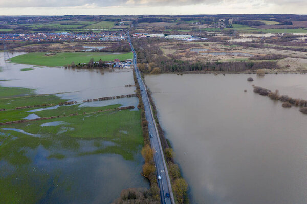 Aerial drone photo of the town of Allerton Bywater near Castleford in Leeds West Yorkshire showing the flooded fields from the River Aire on a rainy winters day during a large flood after a storm.