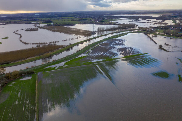 Aerial drone photo of the town of Allerton Bywater near Castleford in Leeds West Yorkshire showing the flooded fields from the River Aire on a rainy winters day during a large flood after a storm.