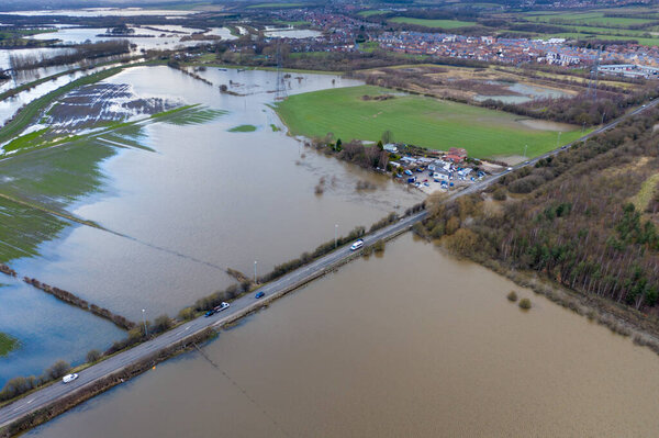 Aerial drone photo of the town of Allerton Bywater near Castleford in Leeds West Yorkshire showing the flooded fields from the River Aire on a rainy winters day during a large flood after a storm.
