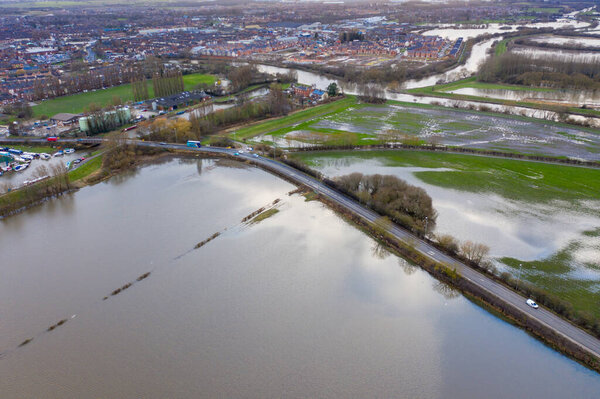 Aerial drone photo of the town of Allerton Bywater near Castleford in Leeds West Yorkshire showing the flooded fields from the River Aire on a rainy winters day during a large flood after a storm.