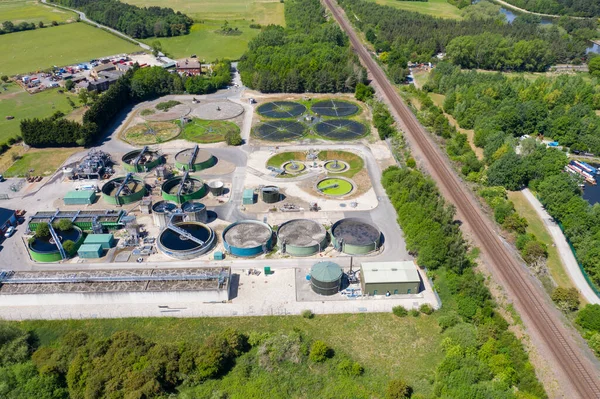 Aerial photo of purification tanks of modern wastewater treatment plant, the waste water and sewage treatment plant is located in the town of Methley Leeds in West Yorkshire UK along side train tracks