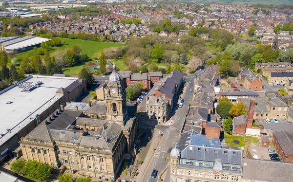 Aerial photo of the village of Morley in Leeds, West Yorkshire in the UK, showing an aerial drone view of the main street and historical old town hall and clock tower