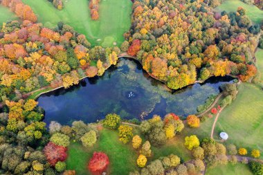 Sonbaharda çekilen hava fotoğrafında Leeds 'teki Roundhay Park olarak bilinen bir parkın güzel sonbahar renkleri bir göl kenarında tipik bir İngiliz parkı ve ormanını gösteriyor..