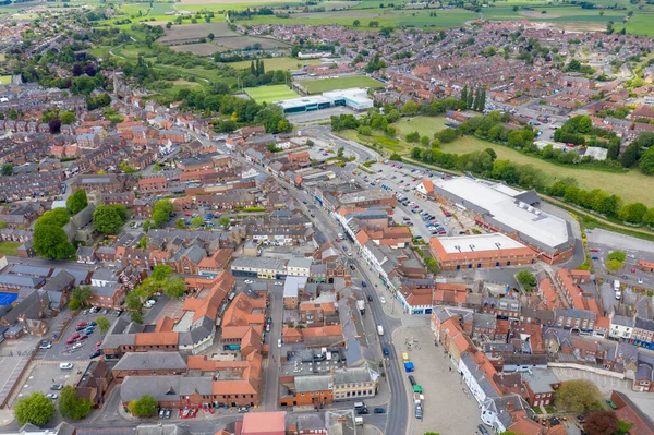 Aerial photo of the historical village town centre of Selby in York North Yorkshire in the UK showing the rows of newly built houses along side the River Ouse and farmers fields in the summer time