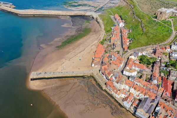 Aerial photo of the beautiful town of Whitby in the UK, North Yorkshire in the UK showing the historic houses and church along side the ocean