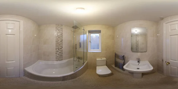 A 360 Degree Full Sphere Panoramic photo of a modern newly built house interior showing a brand new modern bathroom with bath tub, toilet, basin sink and square shower.