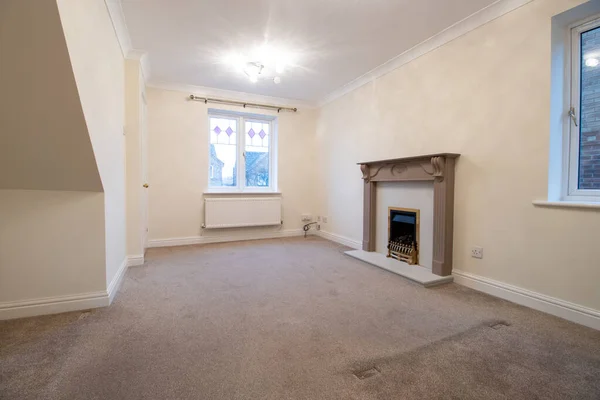 A brand new modern British home showing the living room with a fire place and fire place mantle place