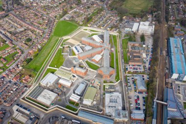 Aerial drone photo of the town centre of Wakefield in West Yorkshire in the UK showing the main building and walls of Her Majesty's Prison, also know as HMP Wakefield taken in the spring time clipart