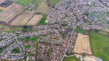 Aerial drone photo of a typical residential housing estate in England showing a very high view of the village of Wakefield in West Yorkshire in the UK taken in the spring time