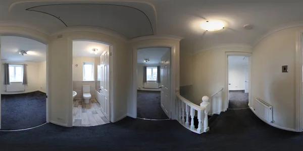 A 360 Degree Full Sphere Panoramic photo of a modern newly built house interior showing the stairs and hallway of the British newly built house