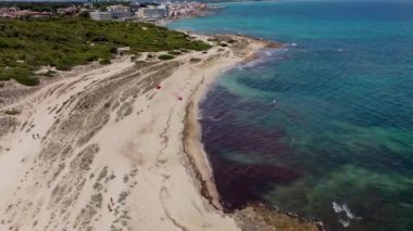 Aerial drone footage of the beach front on the Spanish island of Majorca Mallorca, Spain viewed from above on a bright sunny summers day showing the beach front along sand dunes at S'Arenal d'es Casat