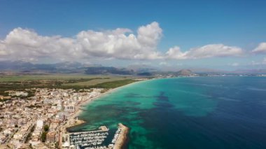Aerial drone footage of the beach front on the Spanish island of Majorca Mallorca, Spain viewed from above on a bright sunny summers day showing the beach front in the village of Can Picafort