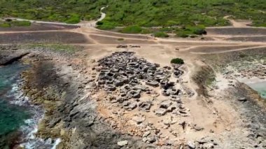 Aerial drone footage of the Spanish island of Majorca Mallorca, Spain showing the Prehistoric cemetery and archaeological site dating back to the 7th century BC, with over 100 tombs.