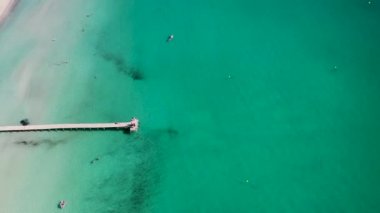 Aerial drone footage of the beach front on the Spanish island Majorca Mallorca, Spain and beach known as Platja de Muro in the village of Alcdia on a bright sunny summers day
