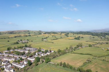 Güneşli bir günde İngiltere 'nin Westmorland ve Furness kentindeki bir pazar kasabası ve sivil bölge olan Kendal şehrinin hava fotoğrafında konut ve caddelerinin güneşli bir günde olduğu görülüyor.