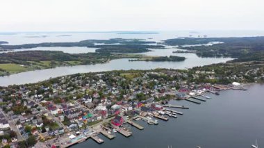 Aerial drone footage of the town of Lunenburg which is a historic port town in Nova Scotia Canada showing the historical colourful buildings by the ocean front in the fall autumn time