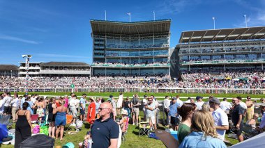 York, Yorkshire UK, 12th July 2025: Photo of crowds of people at the York race course showing the people enjoying the sun and horse racing on a sunny summers day in the UK