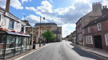 Tadcaster, Yorkshire UK, 7th July 2025: Slow motion footage of the town of Tadcaster showing the historic John Smiths Brewery headquarters and factory located in the British town centre in the summer