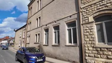 Tadcaster, Yorkshire UK, 7th July 2025: Slow motion footage of the town of Tadcaster showing the historic John Smiths Brewery headquarters and factory located in the British town centre in the summer