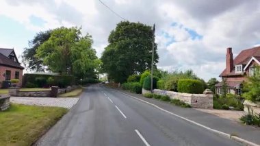 Tadcaster, Yorkshire UK, 7th July 2025: Slow motion footage of the town of Tadcaster showing the road and streets of the historic British town centre on a hot sunny day in the summer time