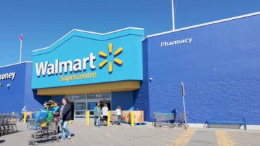 Canada Nova Scotia, 30th September 2025: Slow motion footage of the Walmart supermarket store located in Yarmouth, Canada showing Canadians going in and out of the store shopping on a sunny day