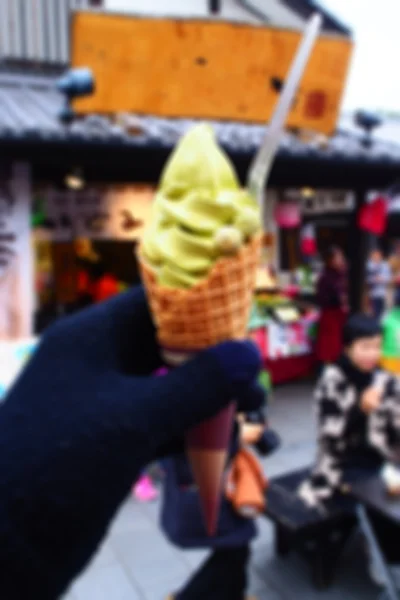 Blurred abstract background of Man's hand holding ice cream — Stock Photo, Image