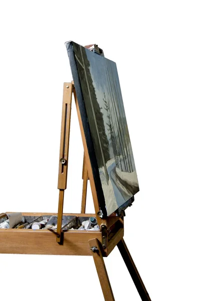 French easel with oil painting of woods and road in snow — Stock Photo, Image