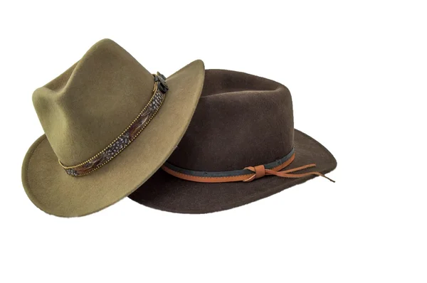 Two outback style hats one green one brown isolated on white Royalty Free Stock Images