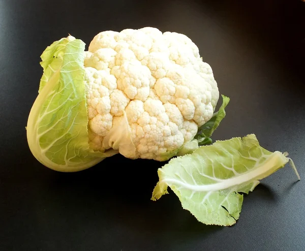 Raw cauliflower with leaves — Stock Photo, Image
