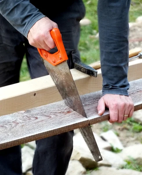 Man working with a saw Royalty Free Stock Images