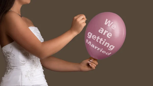 Bride lets a Balloon with Text burst with a needle — Stock Photo, Image