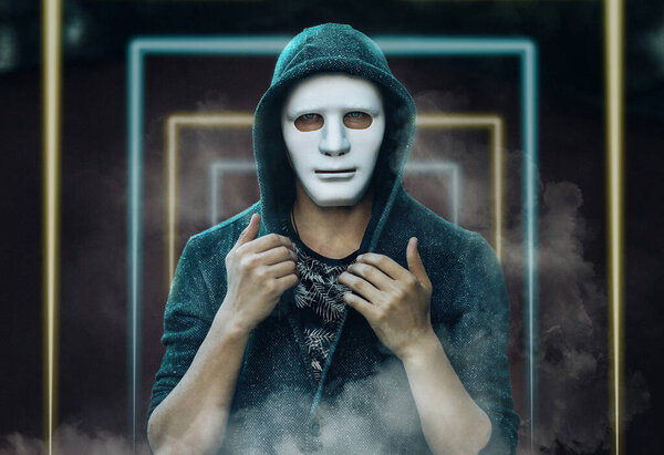 a guy in a white mask and a blue hood is standing in the neon doors and looking at the camera