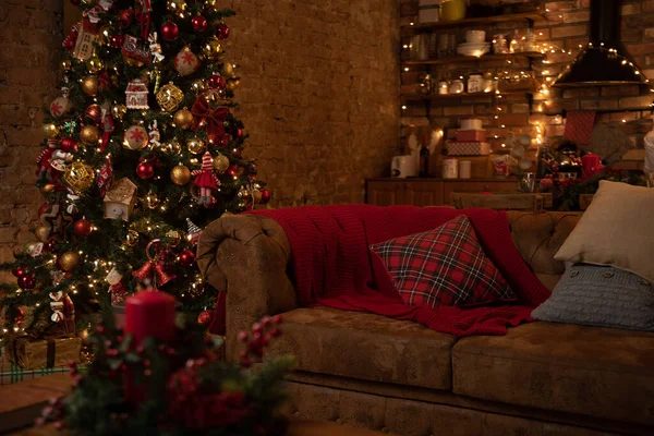 evening New Year's room with a sofa, Christmas tree and garlands