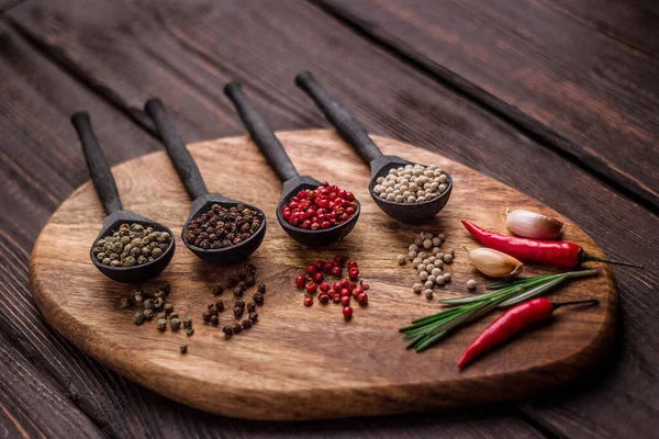 Black Wooden Spoons Colorful Balls Spices — Stock Photo, Image