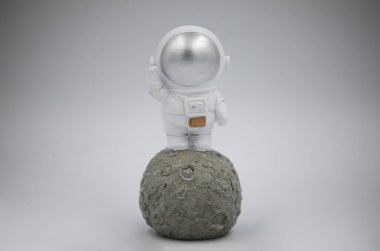 Gri arka planda küçük bir astronotun heykeli