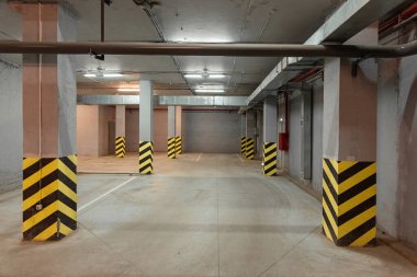 Siyah ve sarı şeritli yeraltı otoparkı.