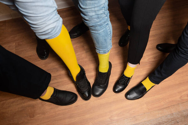 legs in yellow socks and black pants