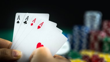 En iyi oyun kartı serisi ve para yongaları tutan el kumar