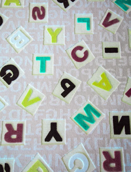 Alphabets sur une surface de tapis de tissu — Photo