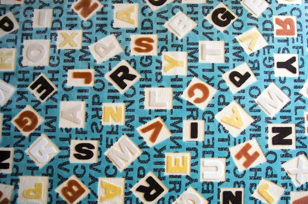 Alphabets sur une surface de tapis de tissu — Photo