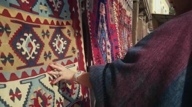 Genç Kadın Anadolu 'ya özgü el yapımı halılara bakıyor