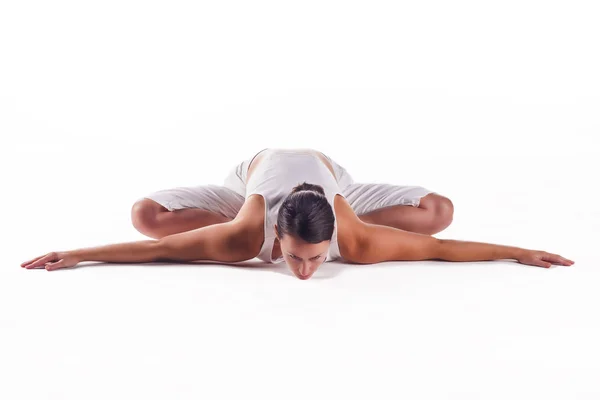 Woman practicing the "Bound Angle Pose" yoga posture Stock Image