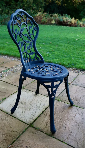 7 November 2020 - London, UK: Portrait image of ornamental garden chair on patio — Stock Photo, Image