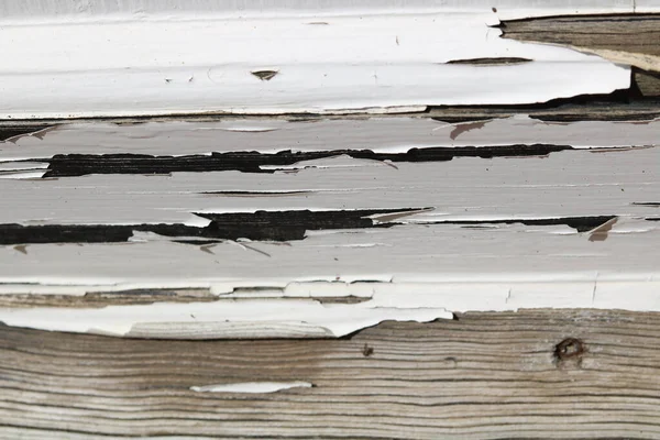 Close up of peeling white paint on old weathered wooden background — Stock Photo, Image