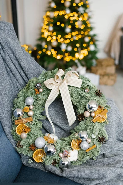 Stylish trending Christmas wreath with Christmas balls, dried orange slices and cinnamon in room decor
