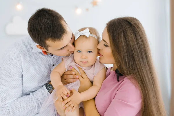 Jóvenes Padres Felices Sostienen Hija Año Sus Brazos Besan Mejilla —  Fotos de Stock