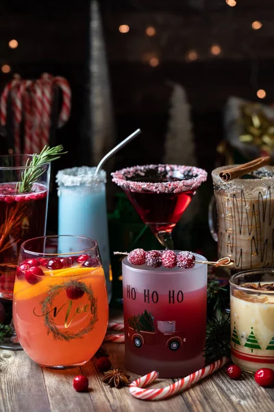 Assorted Christmas cocktails against a dark festive background. — Stock Photo, Image
