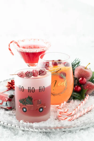 Three Christmas cocktails on a metal serving tray surrounded by Christmas decorations. — Stock Photo, Image